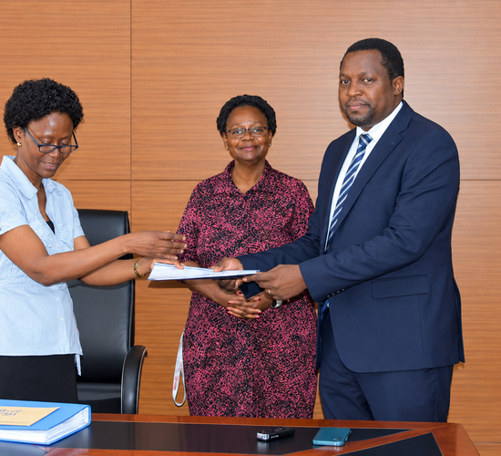 Outgoing Head of Department, Assoc. Prof. Robinah Kulabako (left), hands over the office to the incoming Head of Department, Dr. Philip Nyenje, during a ceremony held at CEDAT on October 5, 2026. In the centre is the Dean, School of Engineering, Assoc. Prof. Eng. Dorothy Okello.