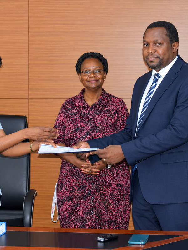 Outgoing Head of Department, Assoc. Prof. Robinah Kulabako (left), hands over the office to the incoming Head of Department, Dr. Philip Nyenje, during a ceremony held at CEDAT on October 5, 2026. In the centre is the Dean, School of Engineering, Assoc. Prof. Eng. Dorothy Okello.