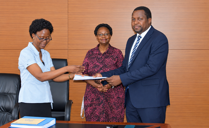 Outgoing Head of Department, Assoc. Prof. Robinah Kulabako (left), hands over the office to the incoming Head of Department, Dr. Philip Nyenje, during a ceremony held at CEDAT on October 5, 2026. In the centre is the Dean, School of Engineering, Assoc. Prof. Eng. Dorothy Okello.