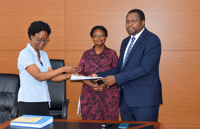 Outgoing Head of Department, Assoc. Prof. Robinah Kulabako (left), hands over the office to the incoming Head of Department, Dr. Philip Nyenje, during a ceremony held at CEDAT on October 5, 2026. In the centre is the Dean, School of Engineering, Assoc. Prof. Eng. Dorothy Okello.